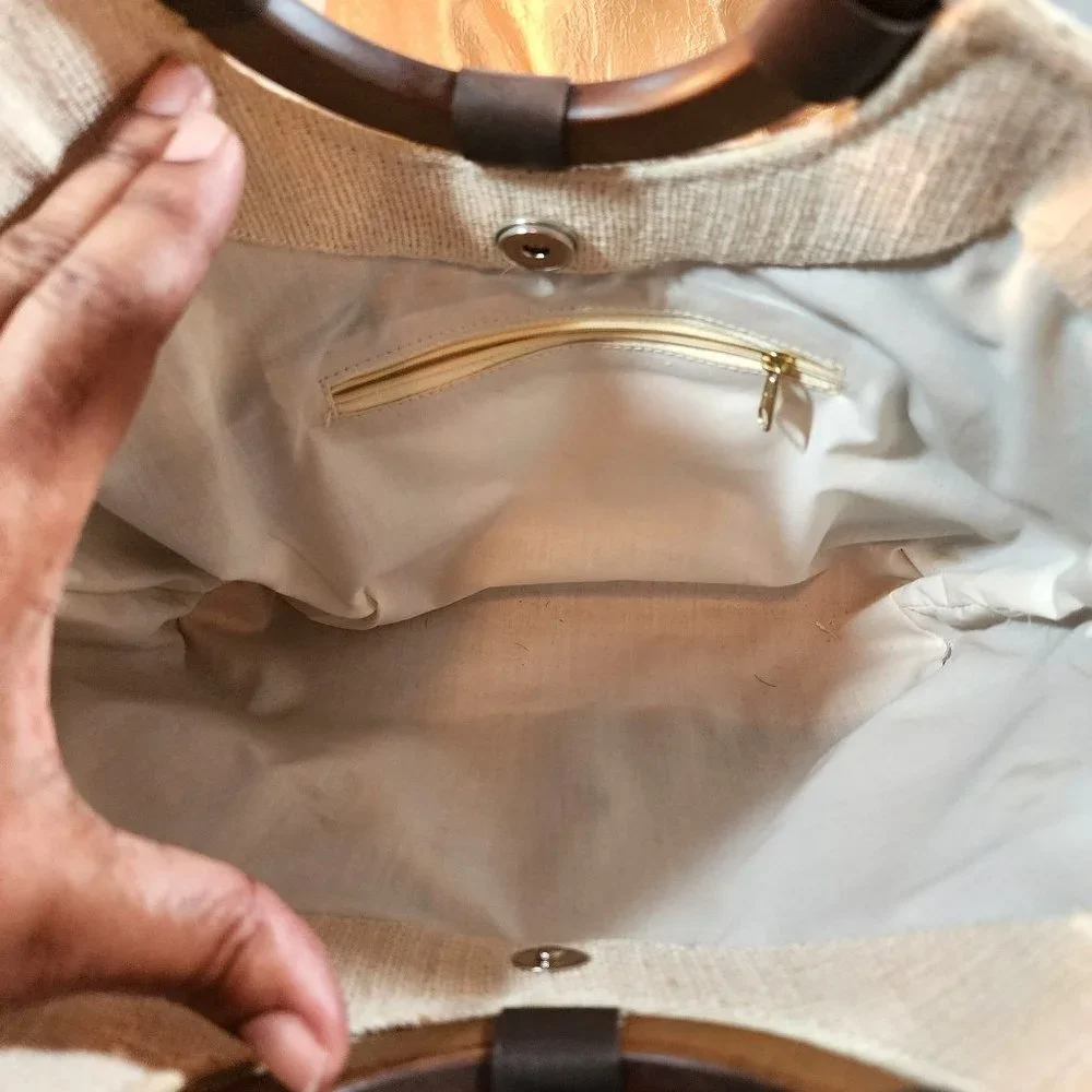 Beige Woven Handbag With Brown Accent at Bottom and Brown Decorative Wood handle